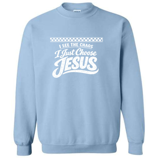 Light blue sweatshirt with white text 'I see the chaos, I just choose Jesus' on a white background